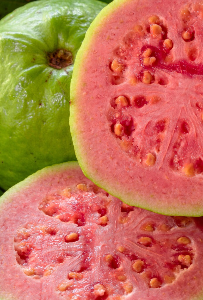 Fresh Red Guavas With Green Leaves On Wooden Demolition Backgrou